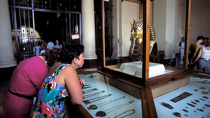 Woman looking in amazement at Tutankhamun's funerary mask on display at the Museum of Egyptian Antiquities, Cairo, Al Qahirah, Egypt