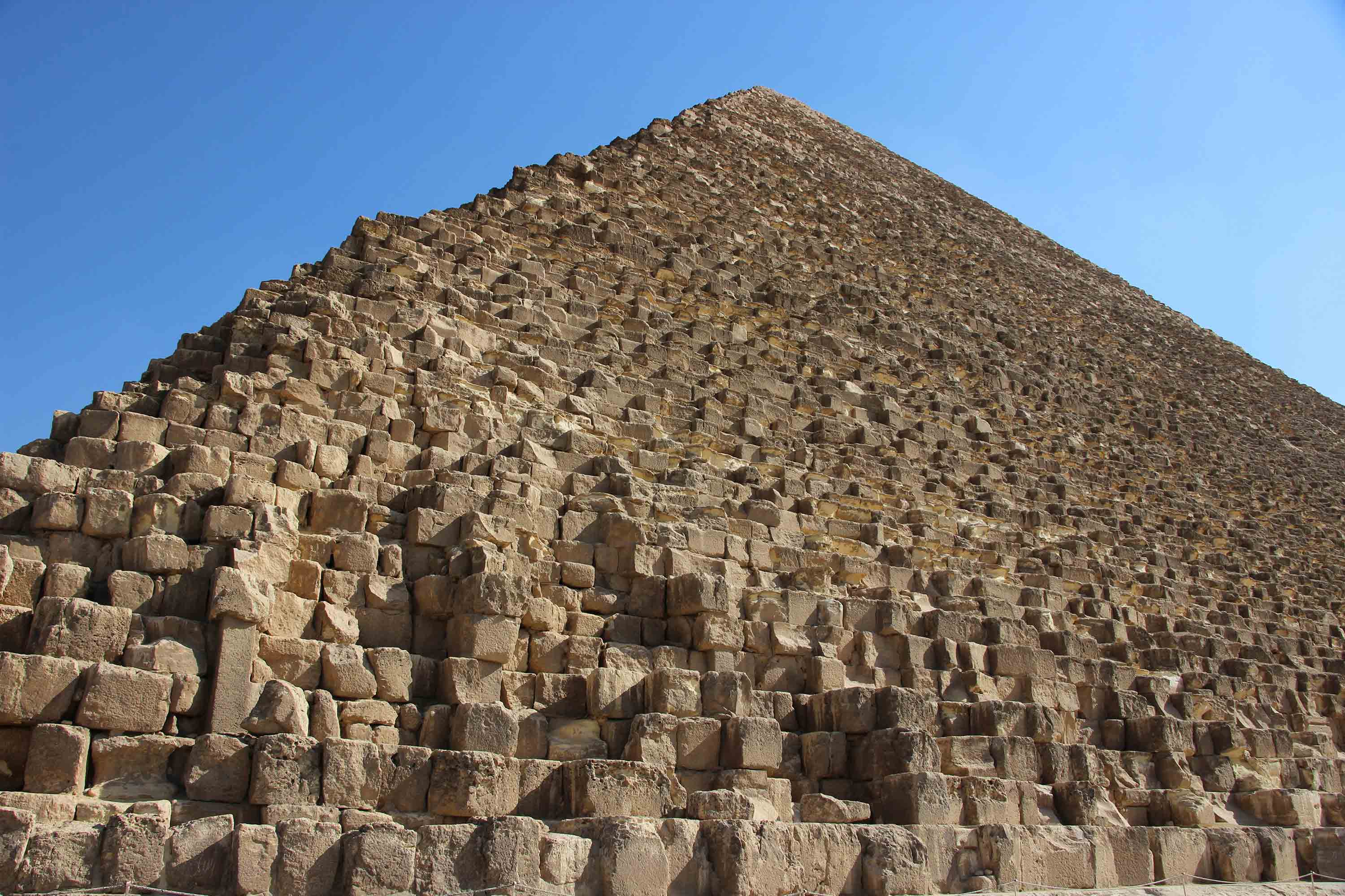 Ground level perspective looking up at the Great Pyramid of Khufu in Egypt’s Giza Pyramid Complex