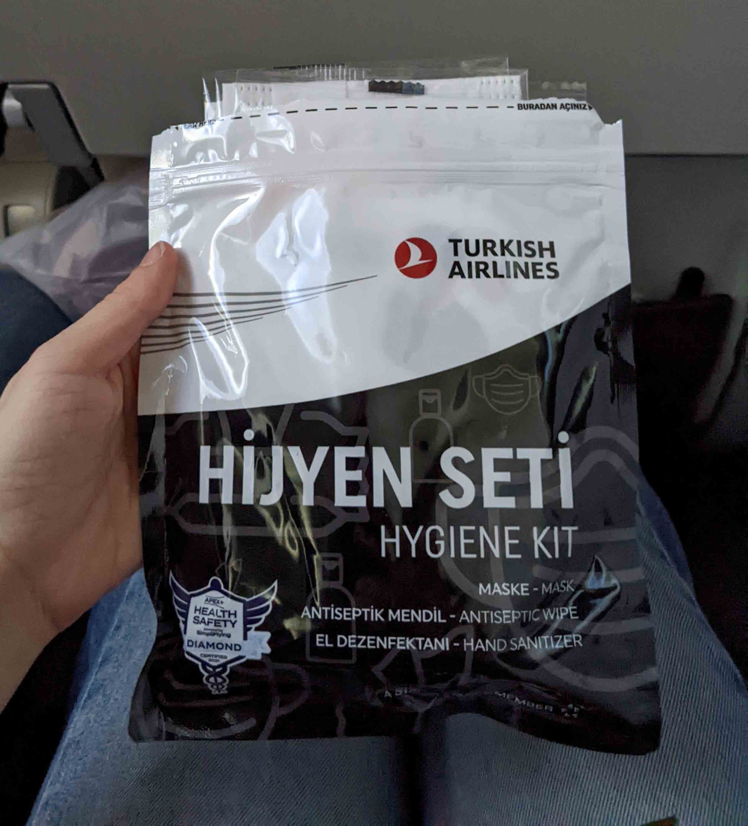 Hygiene kit provided on an international flight with Turkish Airlines, including face masks, antiseptic wipes and hand sanitizer
