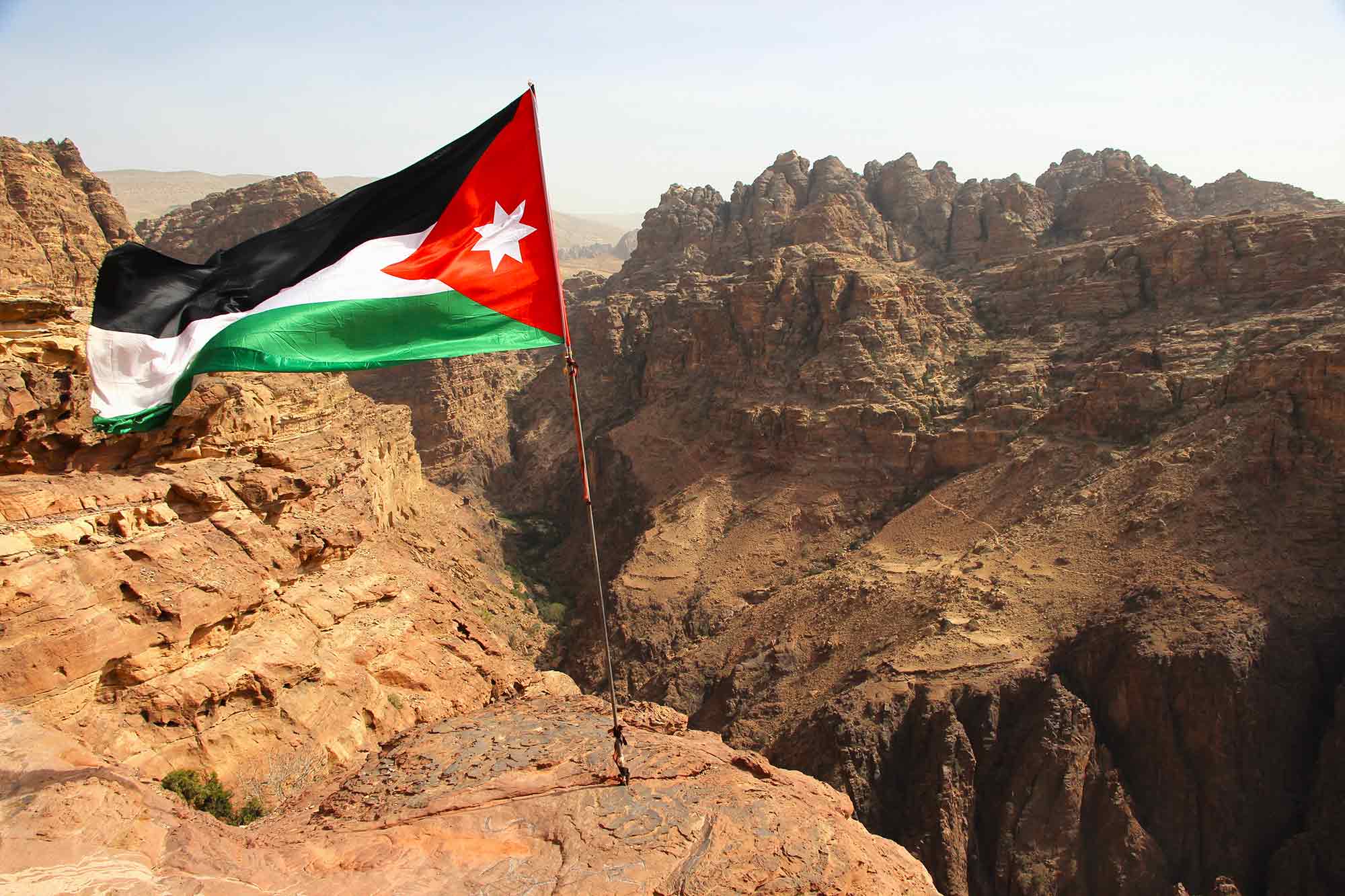 Viewpoint of the desert behind Petra, complete with the Jordan flag