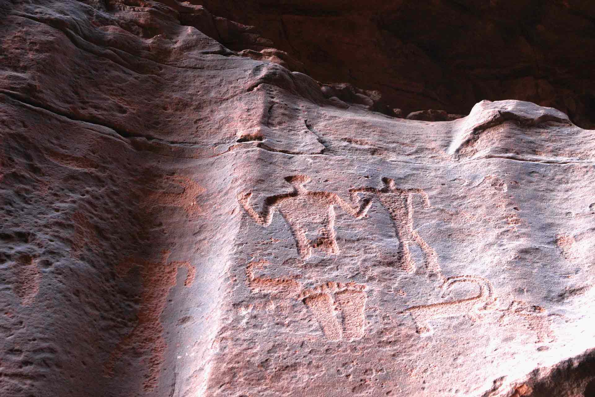 Ancient petroglyphs carved into the walls of Khazali Canyon at Wadi Rum, Jordan