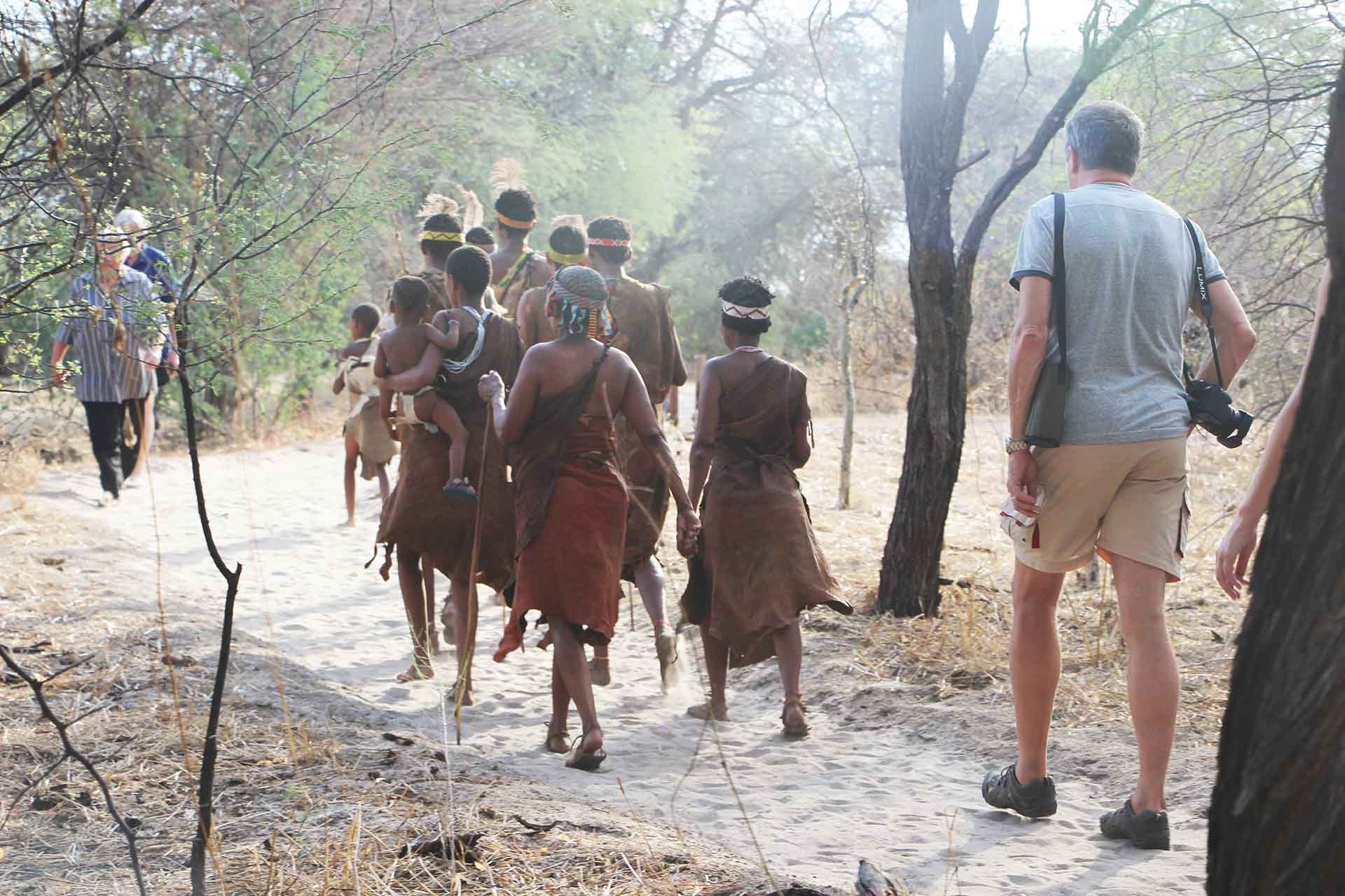 Tourists in Botswana learn about the traditions of the San people