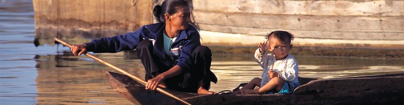 Woman rowing a boat, Tonle Sap, Siem Reap, Cambodia