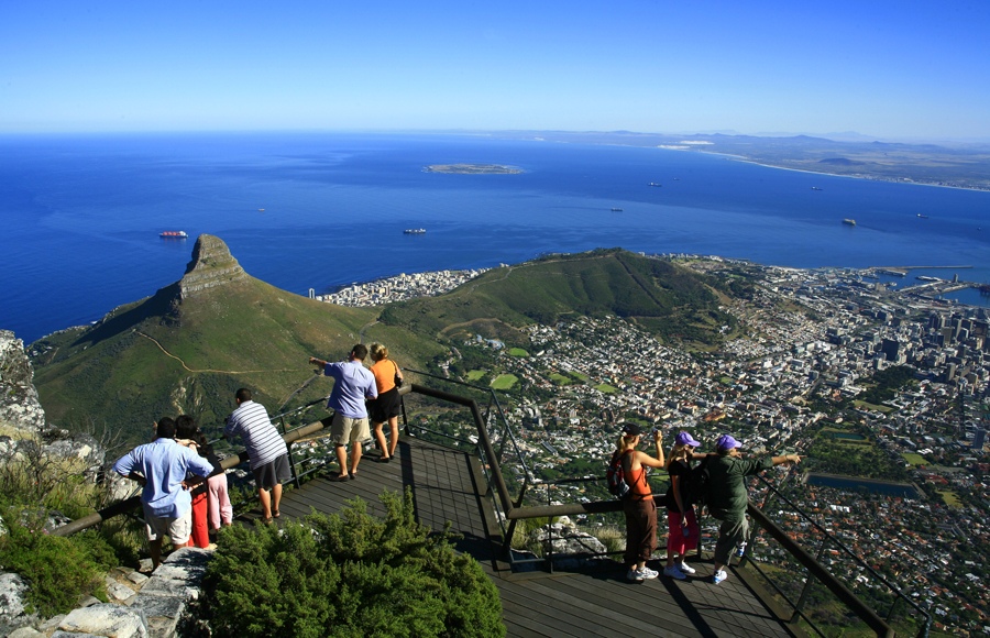 Tourists enjoying breathtaking views of Cape Town from top of Table mountain