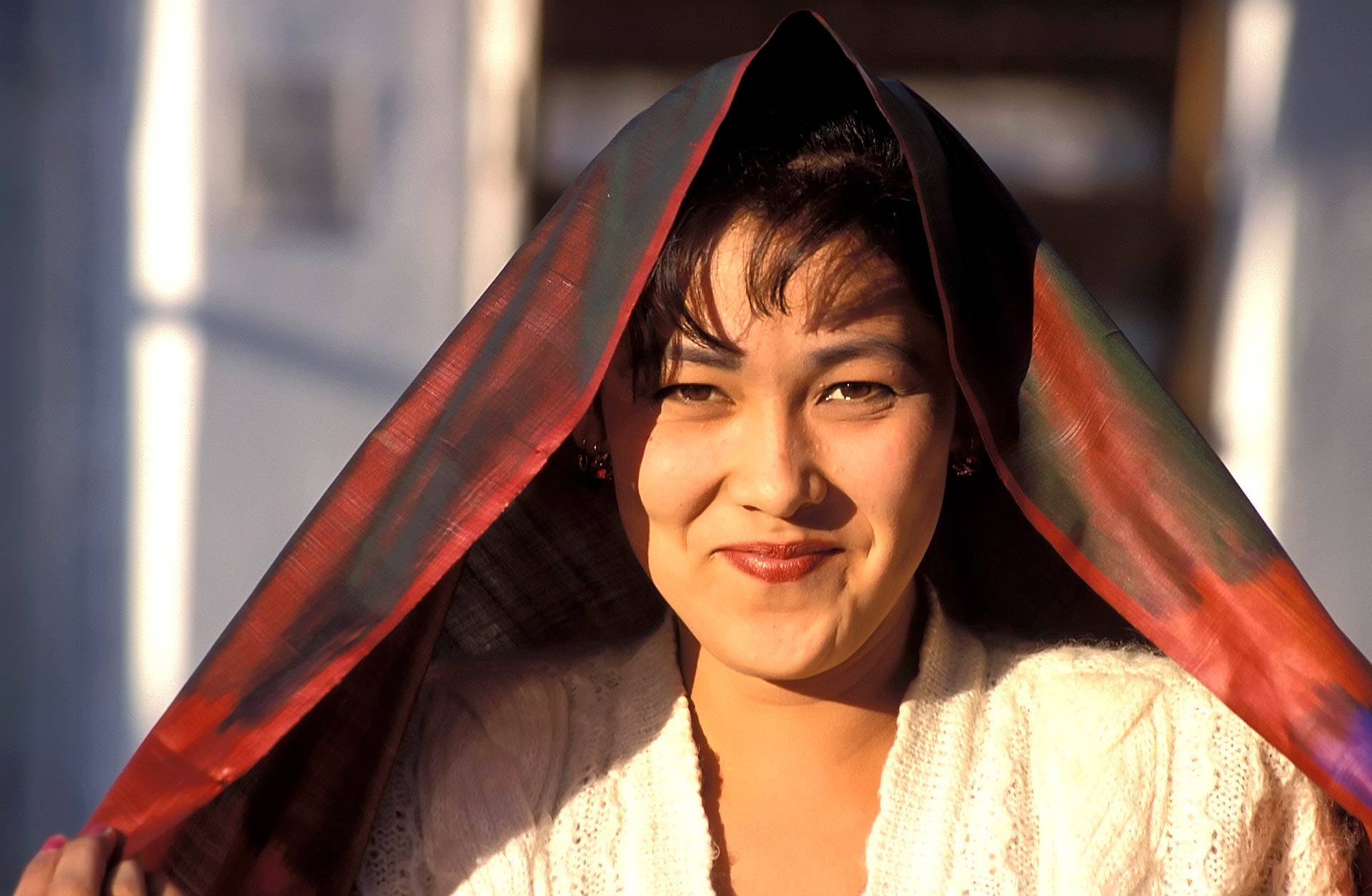 Woman showing silk cloth, Hamza, Fergana, Uzbekistan