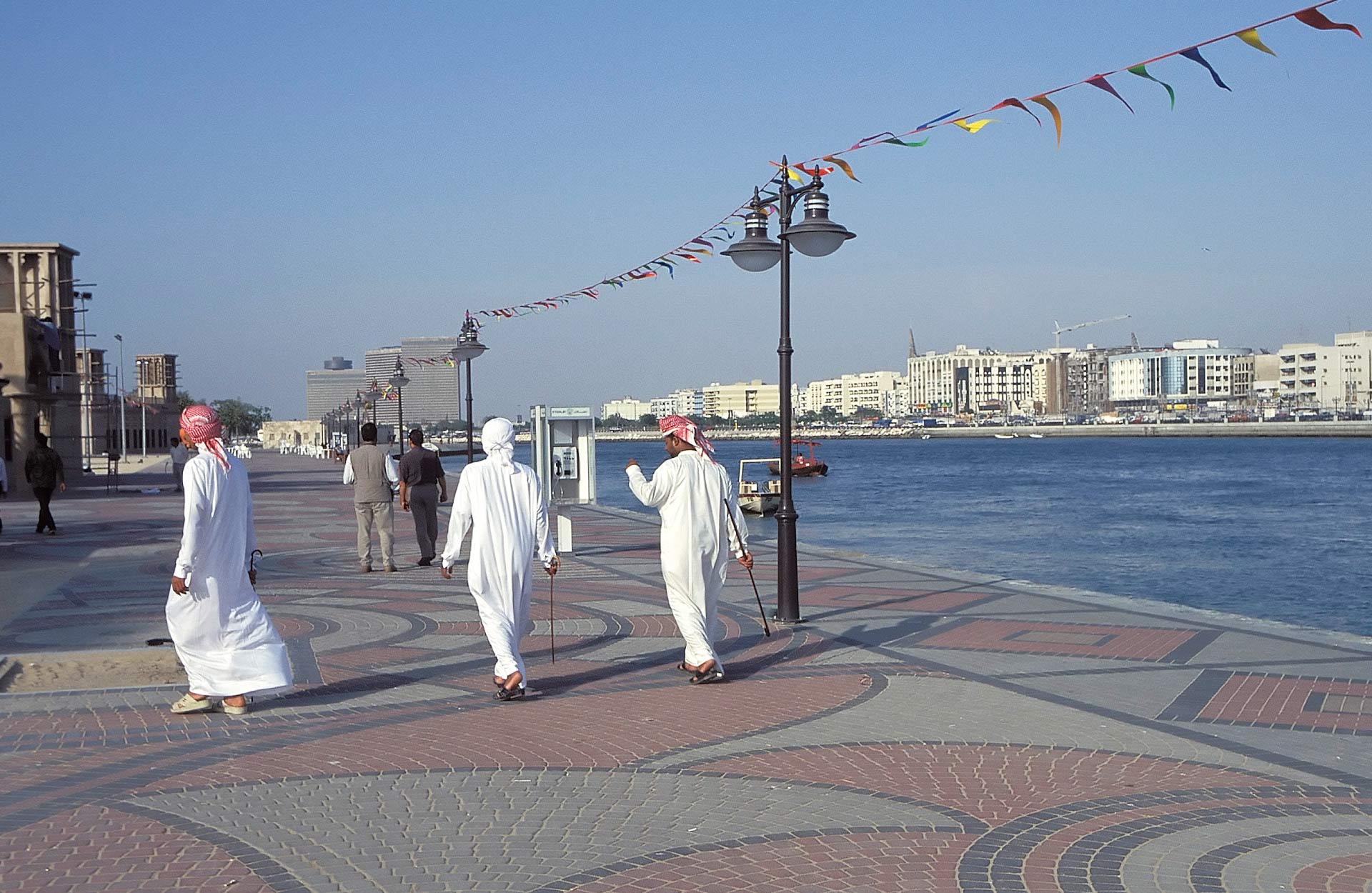 Men walking along the quay, Dubai, United Arab Emirates
