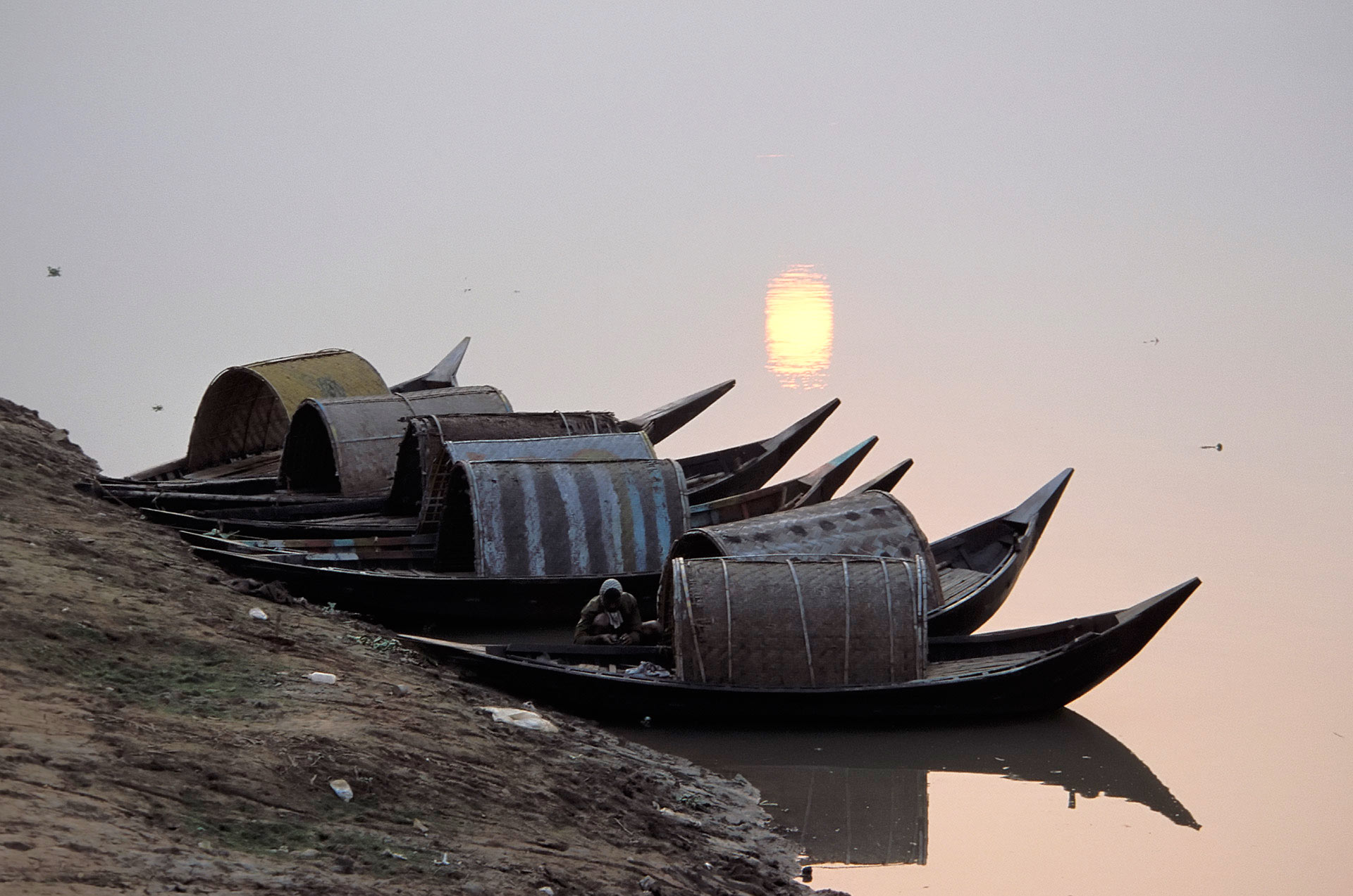 Boats on the Bangai River at sunset, Dhaka, Bangladesh