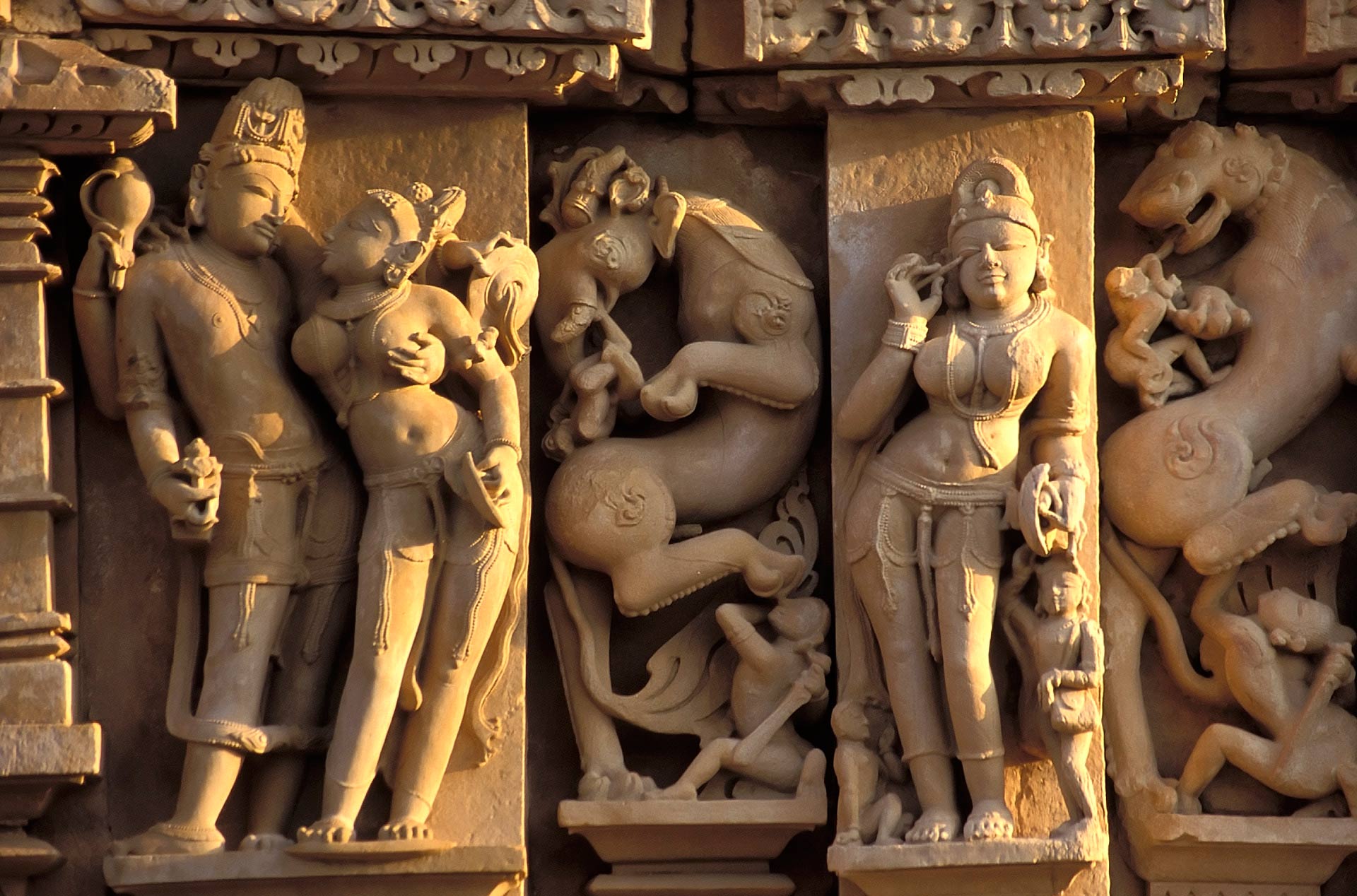 Apsara applying collyrium at the Parsvanath Temple located in the Eastern group of the Khajuraho Group of Monuments, Madhya Pradesh, India