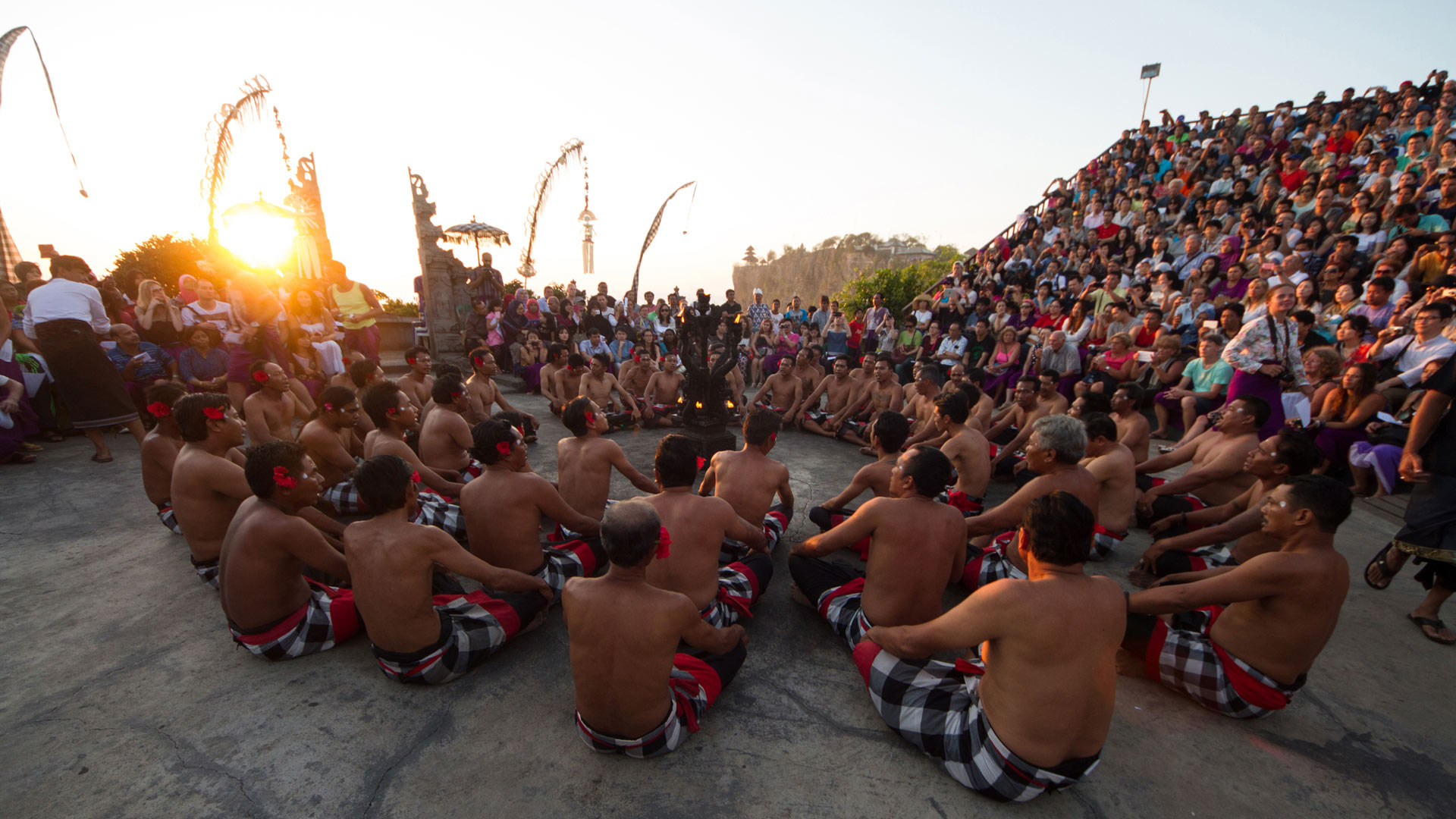 Men sitting in a circle chanting in trance during a Kecak dance performance, Ulu Watu, Bali, Indonesia