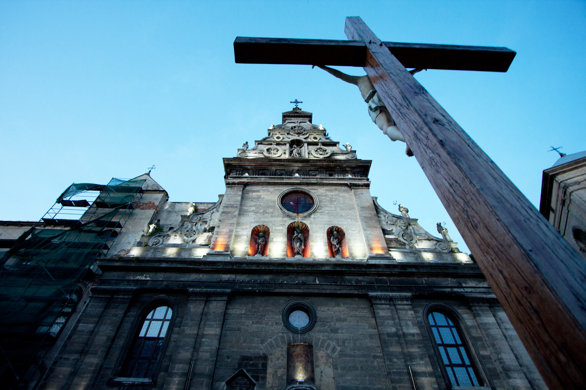 Crucifix and façade of St Andrew Church (Former Bernadine Monastery and Catholic Church) at night, Lviv, Ukraine  