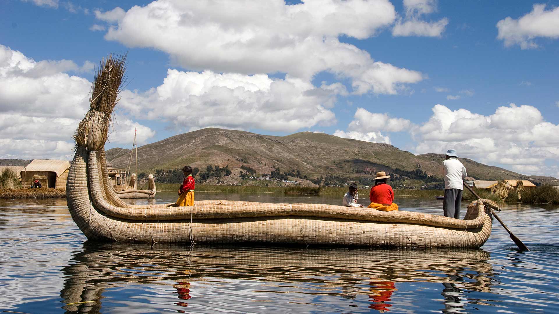 Uro people on board a totora (hollow reed) boat on Lake Titicaca, near Puno